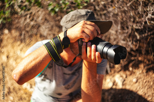 Bild auf Leinwand Photographer taking pictures in nature with professional camera