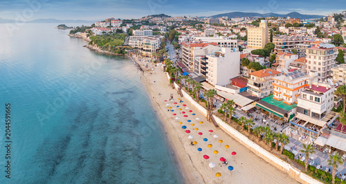 Photos Kusadasi, Turkey, featuring a vibrant beach with colorful umbrellas and resort b