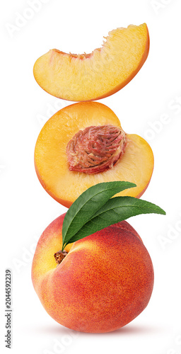 Ripe peach fruit with leaf one cut in half and slice with green leaf