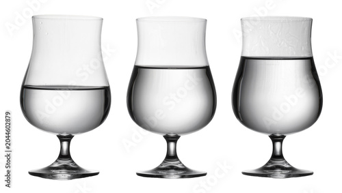 Foto Three clear brandy snifter glasses with water