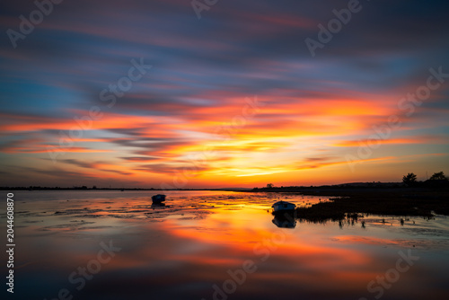 Two Tree Island, Essex Vibrant Sunset Sky Reflecting on Calm Estuary Waters with Moored Boats