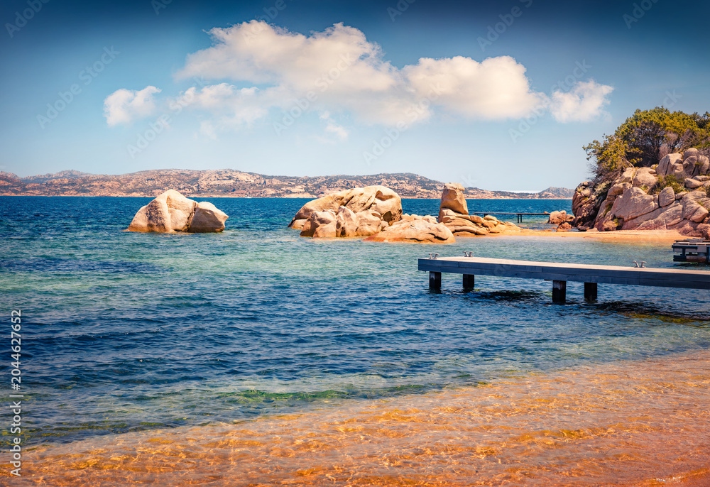 Obraz premium Spectacular summer scene of public beach of Rafael port with wooden pier, Province of Olbia-Tempio, Italy, Europe. Adorable morning view of Sardinia. Nice seascape of Mediterranean sea.