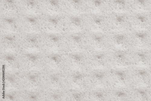 Fotografie Macro photography of a light grey cellulose sponge with a rhythmic geometric pattern