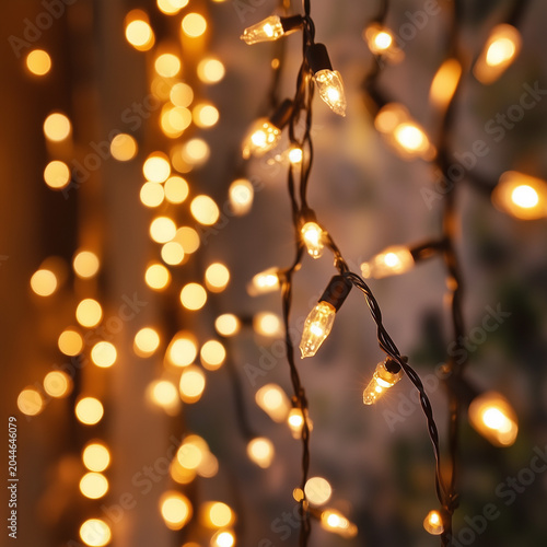 Soft glowing string lights hanging delicately in warm bokeh background with dreamy ambiance