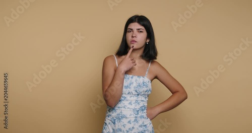 Woman thinks and poses in four different frames against a plain background in a basic studio setting