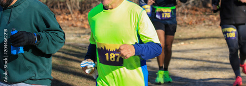 Runners Participate in a Race on a Trail in a Natural Setting
