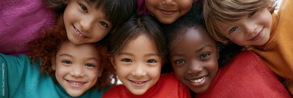 Obraz premium Diverse smiling children group closeup for school banner and education background promoting friendship teamwork and inclusion