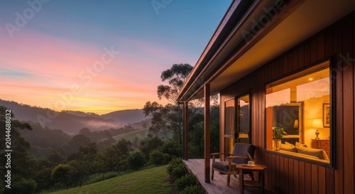 Scenic View of a Wooden House at Sunset with Mountain Range.