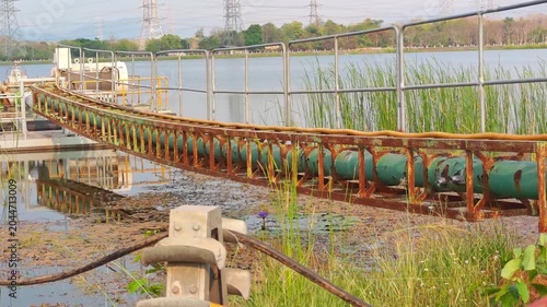 Large industrial green pipes for water transport.