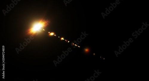 A bright, elongated streak of light cuts across a dark background. The light source appears as a radiant point at the top, with a trail of smaller, diminishing points extending downwards.