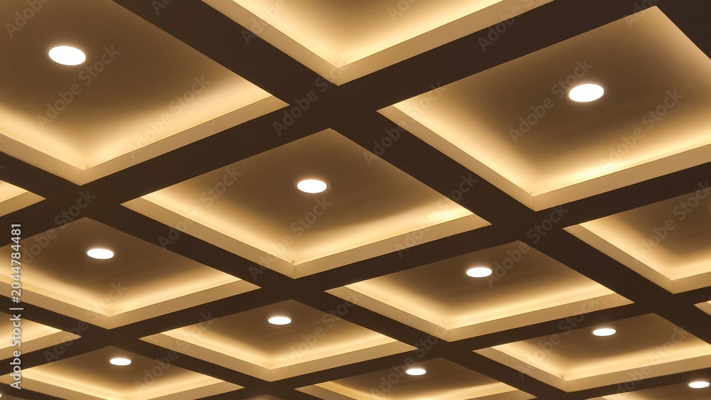 Foto Modern interior ceiling design with square grid pattern and warm hidden LED lighting or downlights