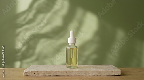 Small glass bottle with golden liquid on wooden surface in soft natural light
