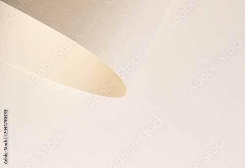 Minimal beige interior surface with soft curved shadow. Abstract wall texture with gentle light and clean space. Neutral background for design, wallpaper, and branding..