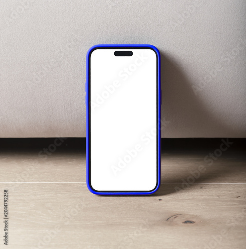 Smartphone with blank screen on wooden floor. Blue case mobile phone standing against a neutral wall. Product mockup for app, advertising, and copy space..