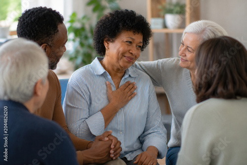 Warm group embraces inside cozy living room