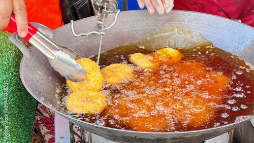 Shrimp Donuts Deep Frying in Hot Oil, Crispy Seafood Street Food Snack Cooking