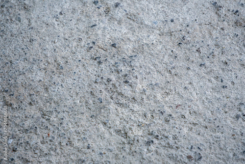 Speckled gray sand or aquatic substrate, suitable for an aquarium bottom, featuring natural black mineral grains and textures.