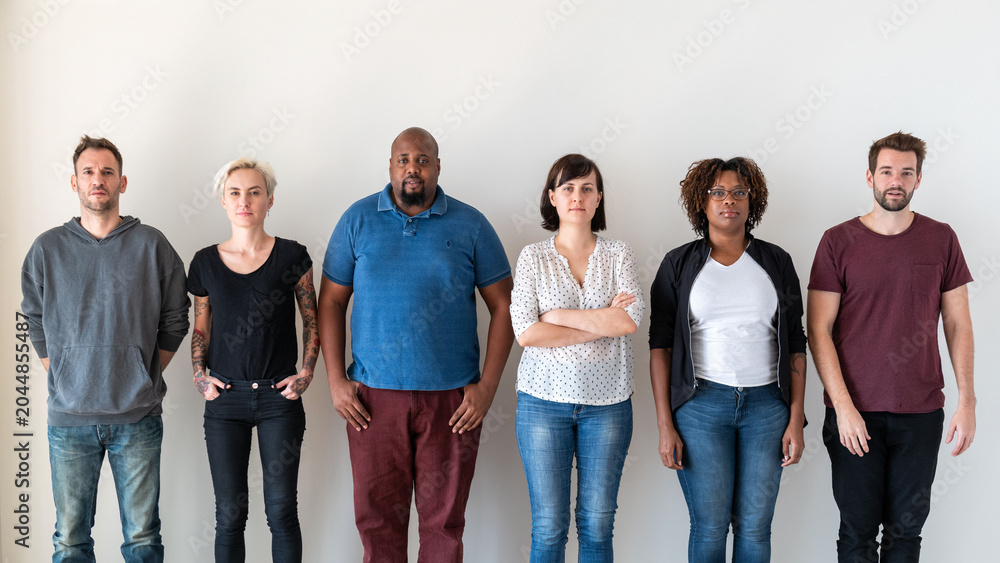 Obraz premium A diverse group of six people standing against a white background.
