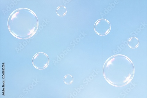 Soap bubbles floating against clear blue sky background