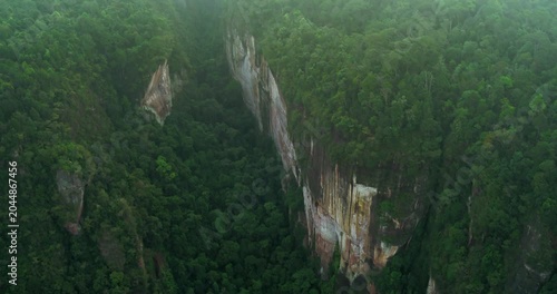 Aerial view of cliff edge disappearing into dense fog and clouds