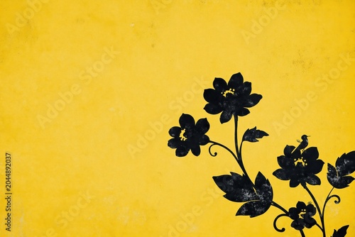 Black flowers against a yellow background with a simple design in a bright setting