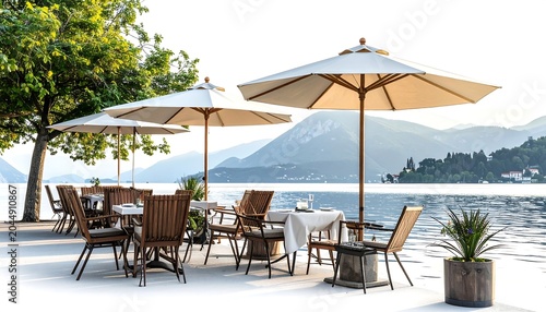 A serene outdoor dining area with umbrellas and chairs overlooking a body of water