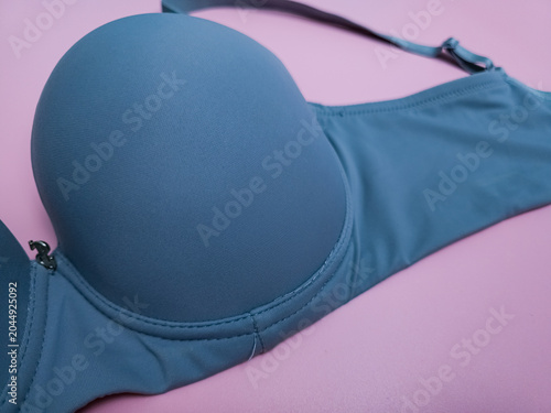 Blue seamless smooth luxury women T-shirt bra on pink background.