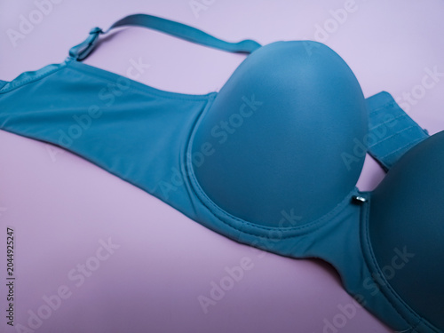 Blue seamless smooth luxury women T-shirt bra on pink background.