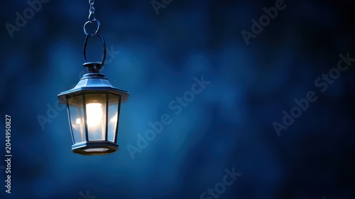 Vintage lantern shining warm light in dark blue background