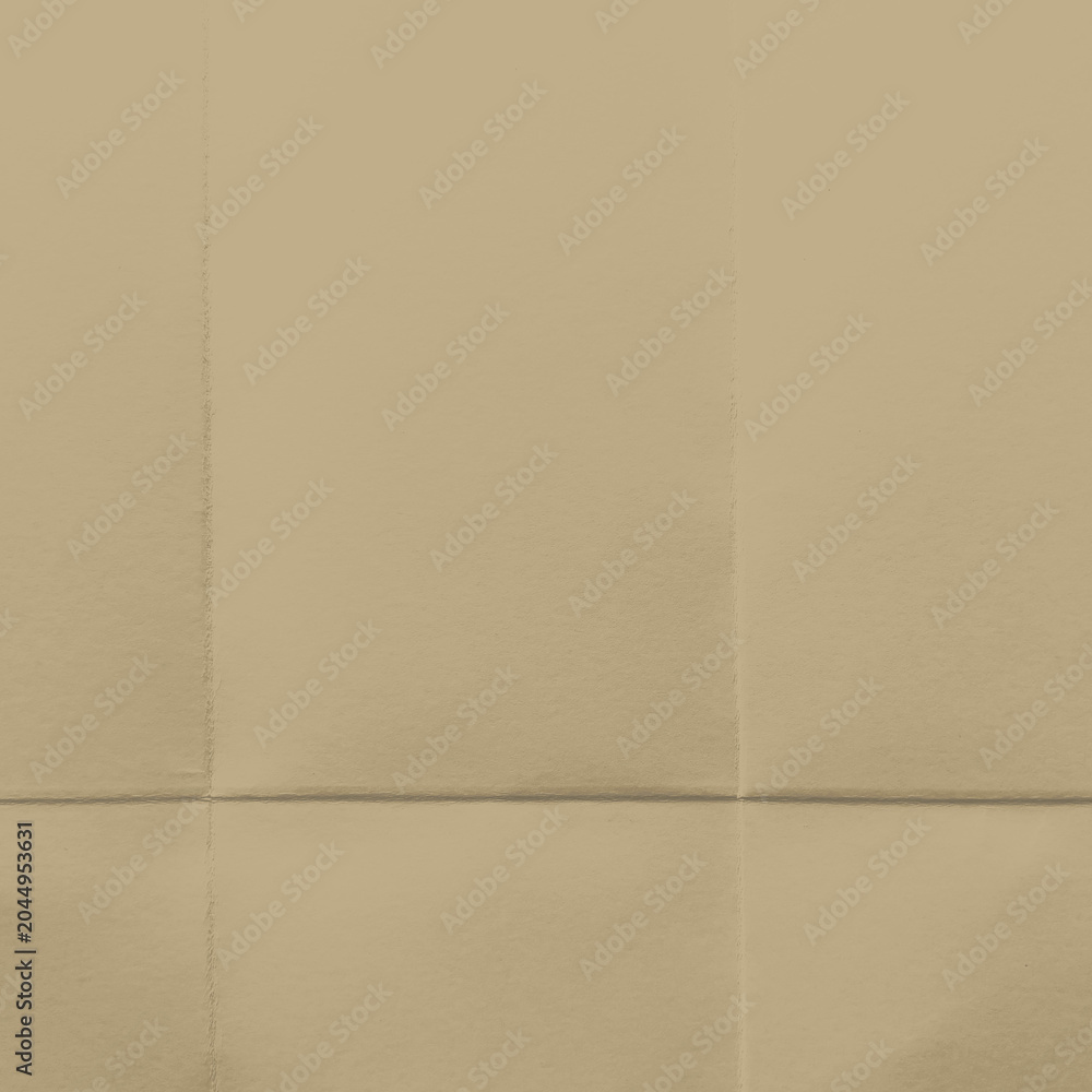 Fototapeta premium Beige folded paper texture with subtle creases and shadows.