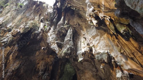 Majestic Limestone Cave Interior With Sunlight and Greenery
