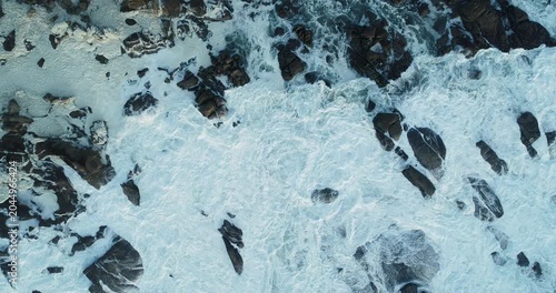Top down view of rough ocean waves crashing on rocks The Concept of natural power
