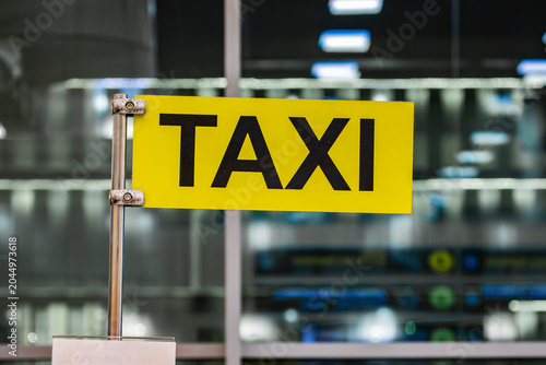 Photography Yellow sign with the word TAXI on the counter at Domodedovo Airport