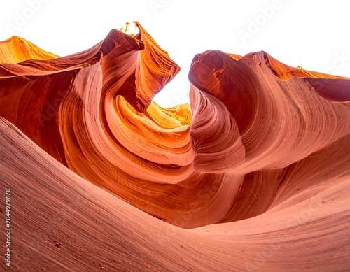A stunningly eroded rock formation with smooth, curved layers in shades of orange and red, resembling a wave