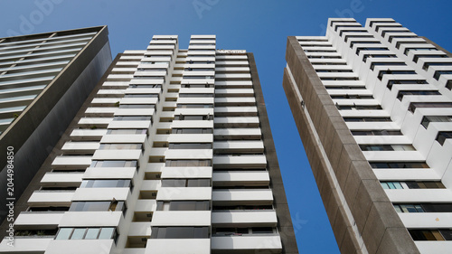 Modern apartment buildings view from below against blue sky