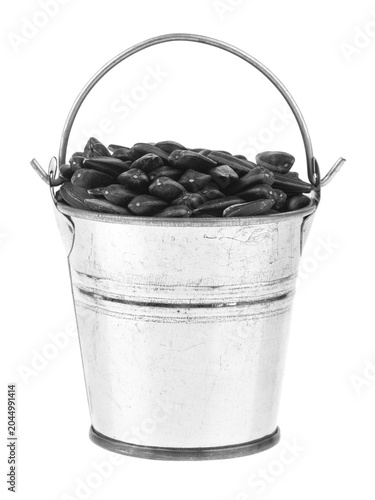 Sunflower seeds in a bucket isolated on white background.