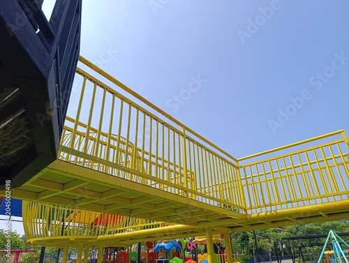 Bright Yellow Playground Ramp and Railings Overhead