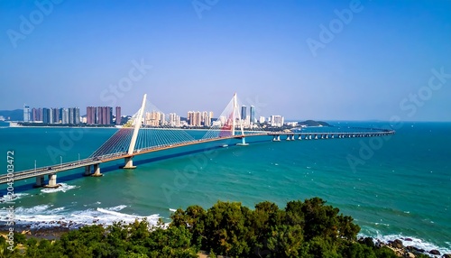 Modern Cable Stayed Bridge Stretching Across Turquoise Sea Near Coastal City Skyline