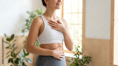 Woman practicing yoga in a serene indoor setting.
