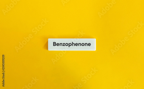 Benzophenone Chemical Ingredient Text on a White Block Against a Bright Yellow Background