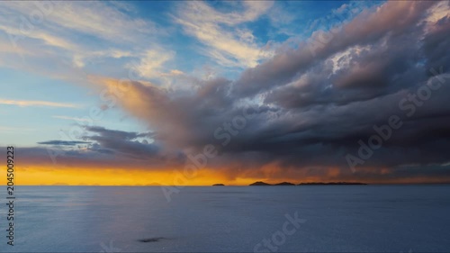 Dramatic Storm Clouds Over Calm Ocean at Sunset With Distant Islands