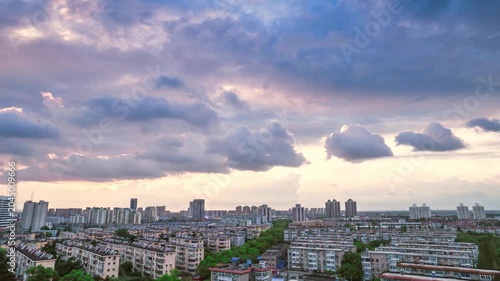 Dramatic Sunset Clouds Over Modern Residential City Skyline