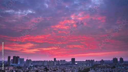 Dramatic Sunset Clouds Over Modern City Skyline