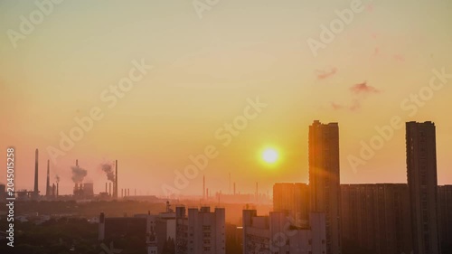 Industrial City Skyline at Sunrise with Smokestacks and High Rise Buildings