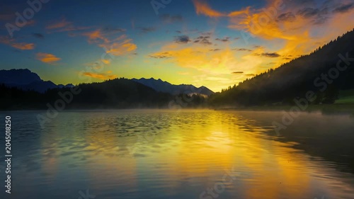 Misty Mountain Lake at Sunrise with Colorful Sky Reflection