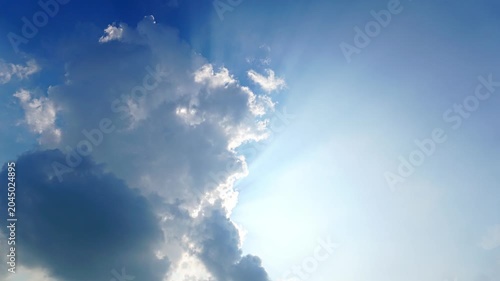 Dramatic Sun Rays Breaking Through Clouds in Blue Sky