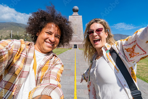 Tableau sur toile Diverse friends celebrating on the equator line at mitad del mundo under a clear