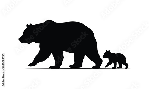 Silhouette of a mother bear and her cub walking side by side in a natural outdoor setting