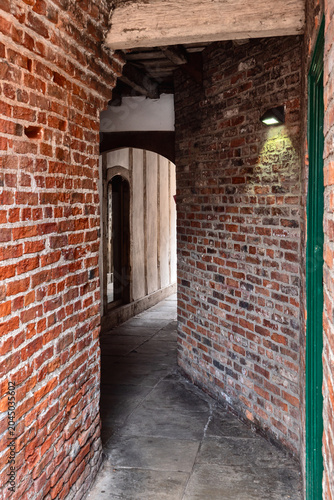 the narrow entrance to coffee yard in york an medieval alley connecting several historic buildings connecting the city streets