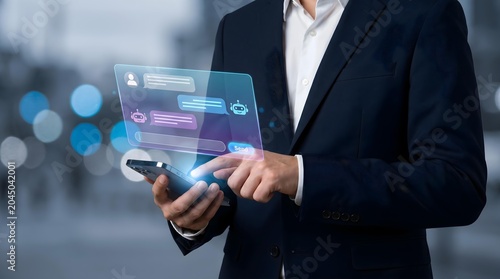 Business professional interacts with a futuristic holographic tablet interface in a modern office setting